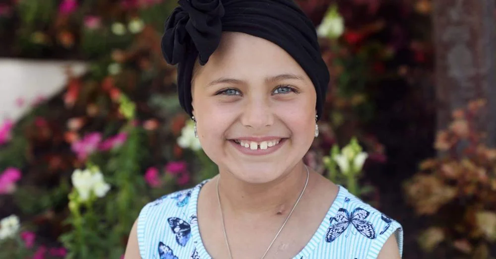sweet young girl with head wrap smiling warmly