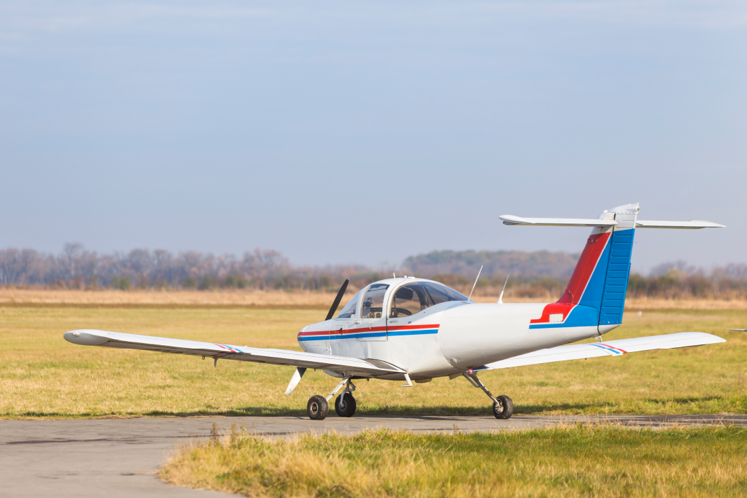 private single engine aircraft sitting on tarmac